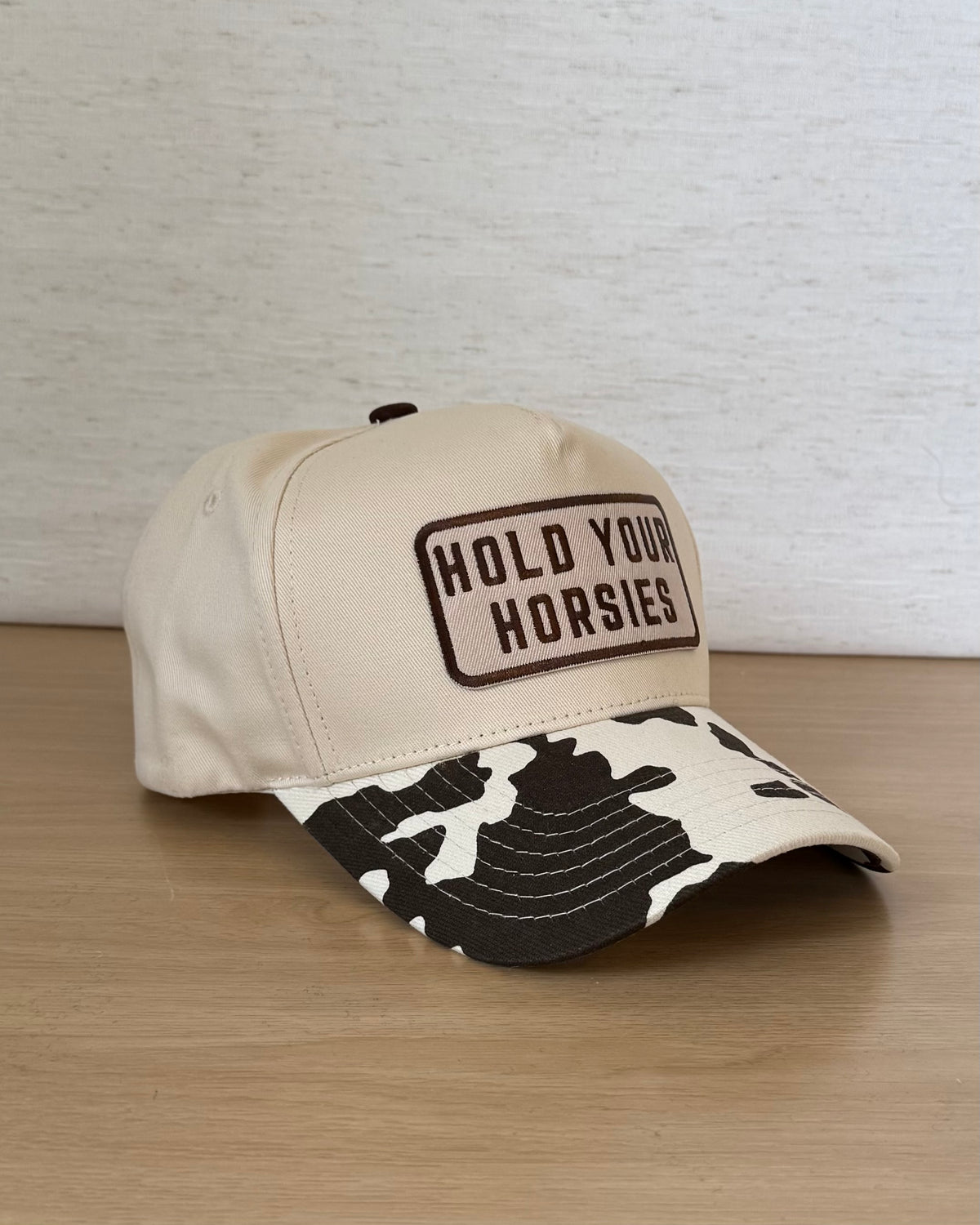 The Hold Your Horsies Cap — Ivory Snapback with Cow Print Bill (OS)